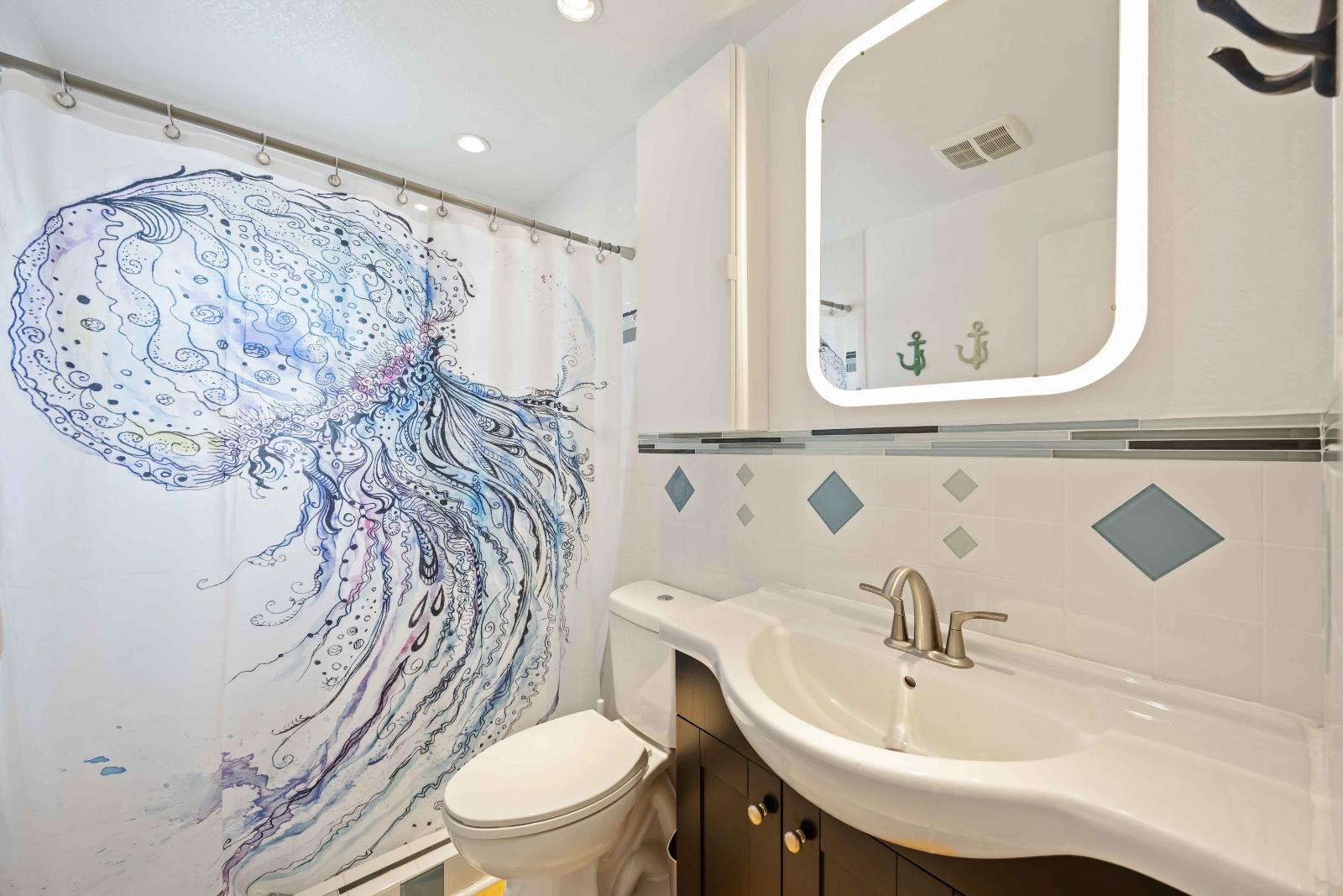 Blue Gecko bathroom with jellyfish shower curtain at Gecko House Manasota Key