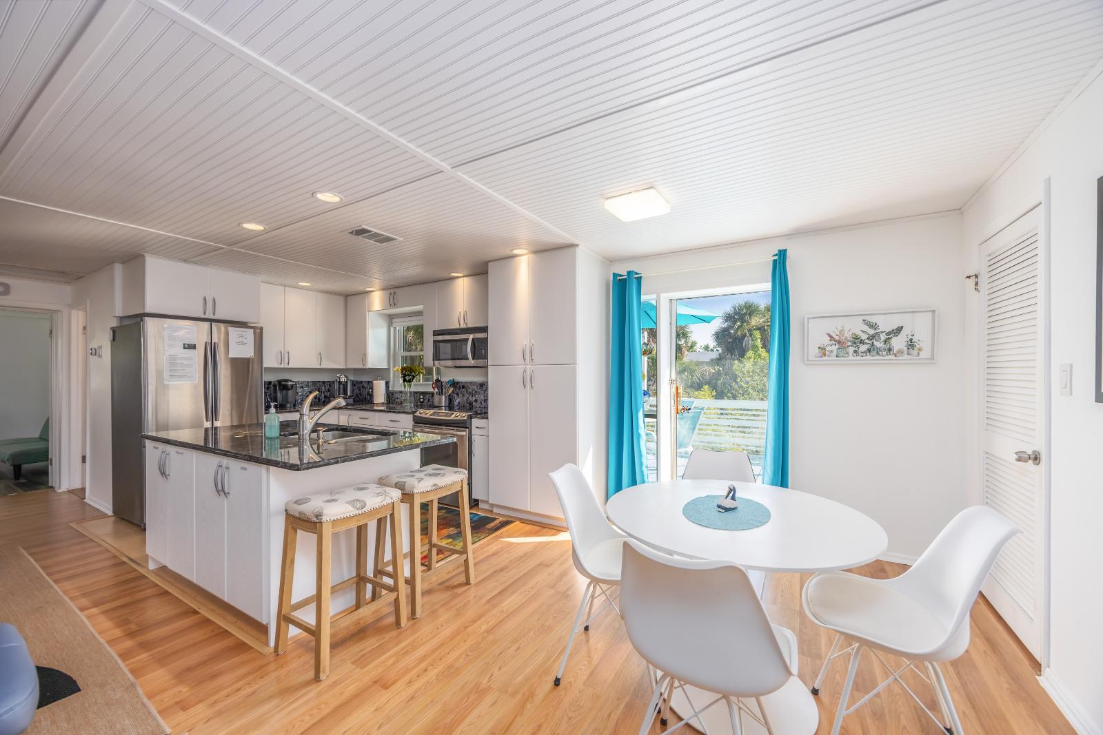 Blue Gecko kitchen with stainless steel appliances and granite island at Gecko House Manasota Key