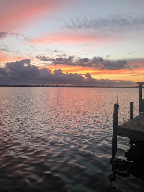 Pink dawn light over Lemon Bay beside the private dock at Gecko House