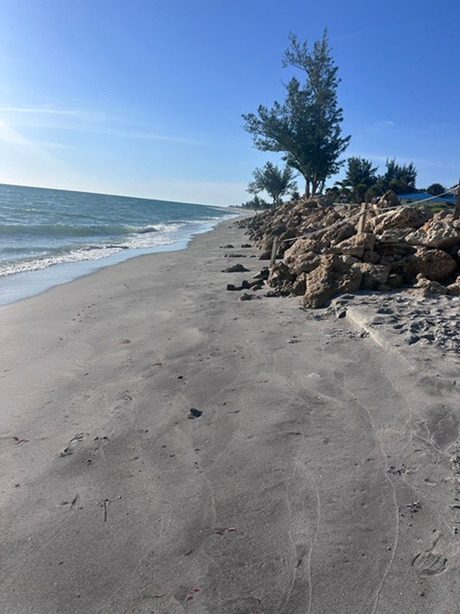 Sandy beach and rock jetty a short walk from Gecko House on Manasota Key