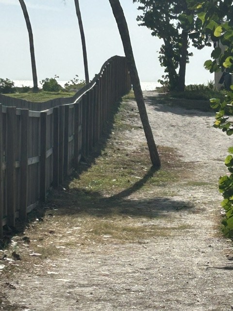 Sandy beach path beside the fence line at Gecko House