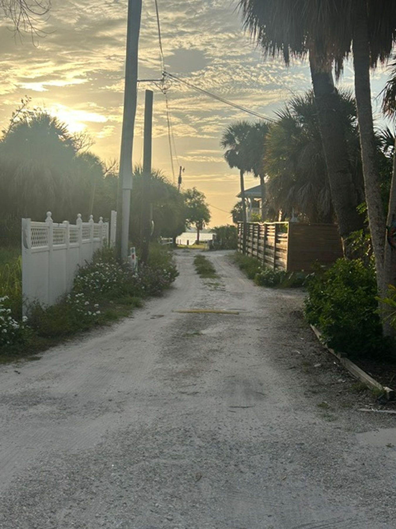 Gravel path leading from Gecko House down toward the private dock