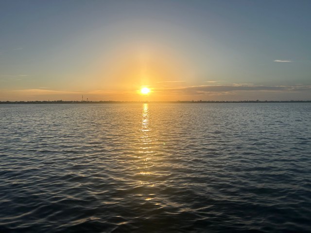 Calm water and soft sunrise light over Lemon Bay at Gecko House