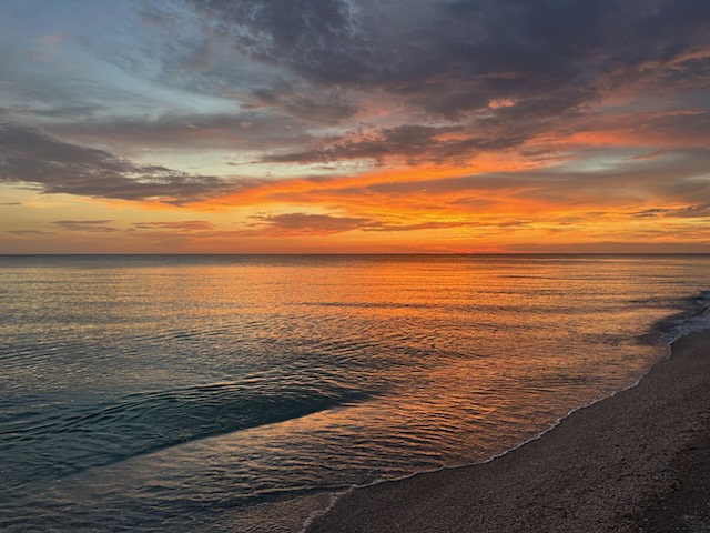 Orange Gulf sunset from the shoreline a short walk from Gecko House